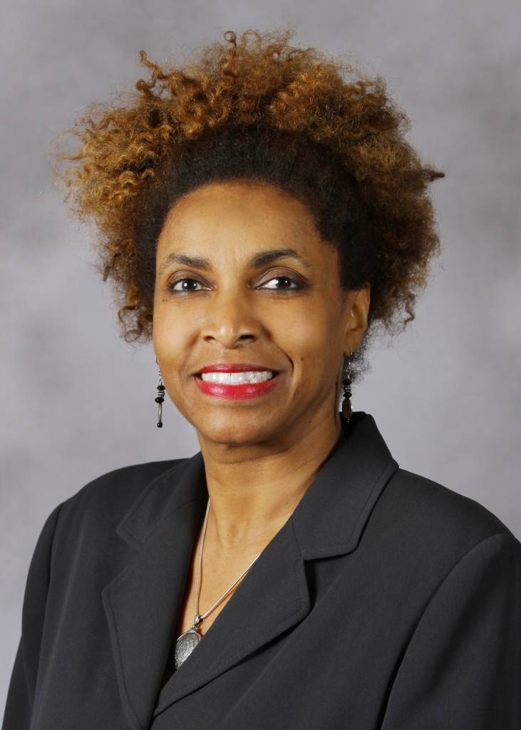 A portrait of a woman smiling into the camera