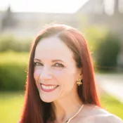 A woman smiling into the camera