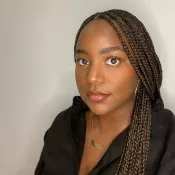 A woman smiling and looking into the camera