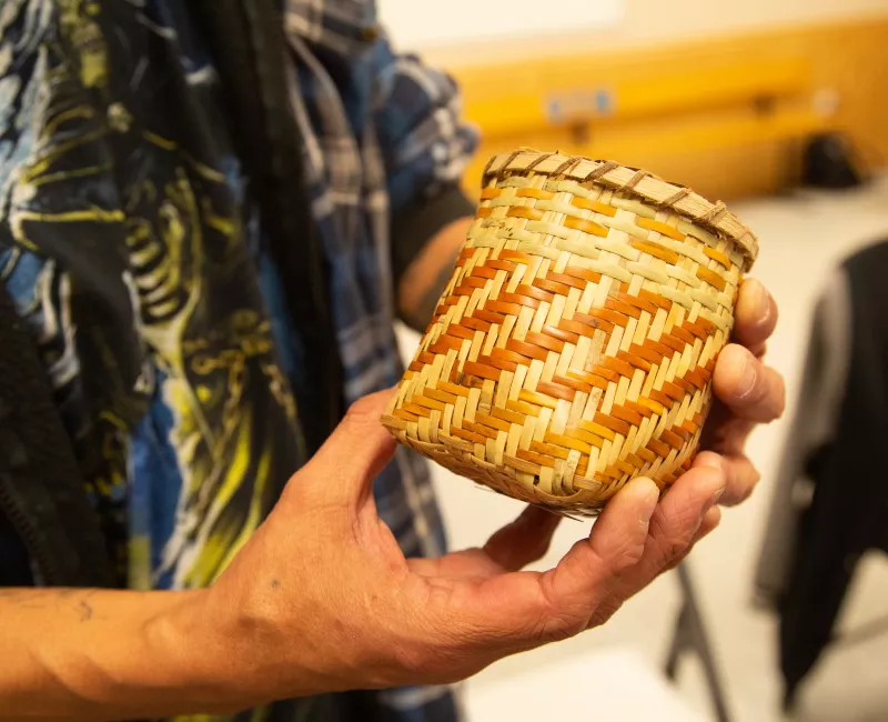 Hands holding a Cherokee basket
