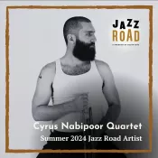A man holding a trumpet and looking to the side
