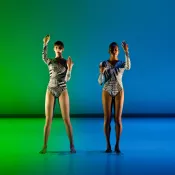 Two dancers with blue and green background
