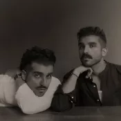 Two men in black and white looking into the camera