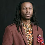 Person with wearing a colorful suit and shirt.