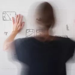 Amy Pleasant turned away from camera hanging a sketch