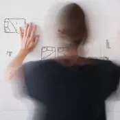 Amy Pleasant turned away from camera hanging a sketch