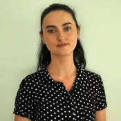 A woman with a slight smile looking into the camera