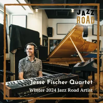 A man sitting at a piano and smiling