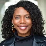A woman smiling into the camera