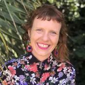 A person smiling and looking into the camera