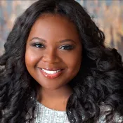A woman smiling into the camera