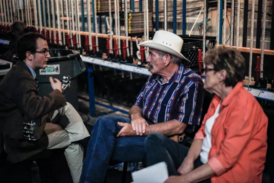 Hughett talking with singers