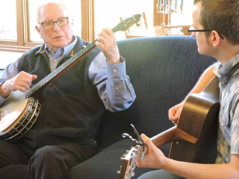 Playing banjo on sofa