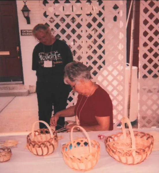Charlene weaving at a table