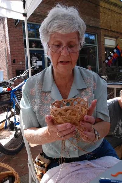 Charlene weaving a basket