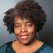 A woman smiling into the camera
