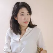 A woman with a slight smile looking into the camera