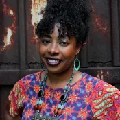 A woman smiling and looking into the camera